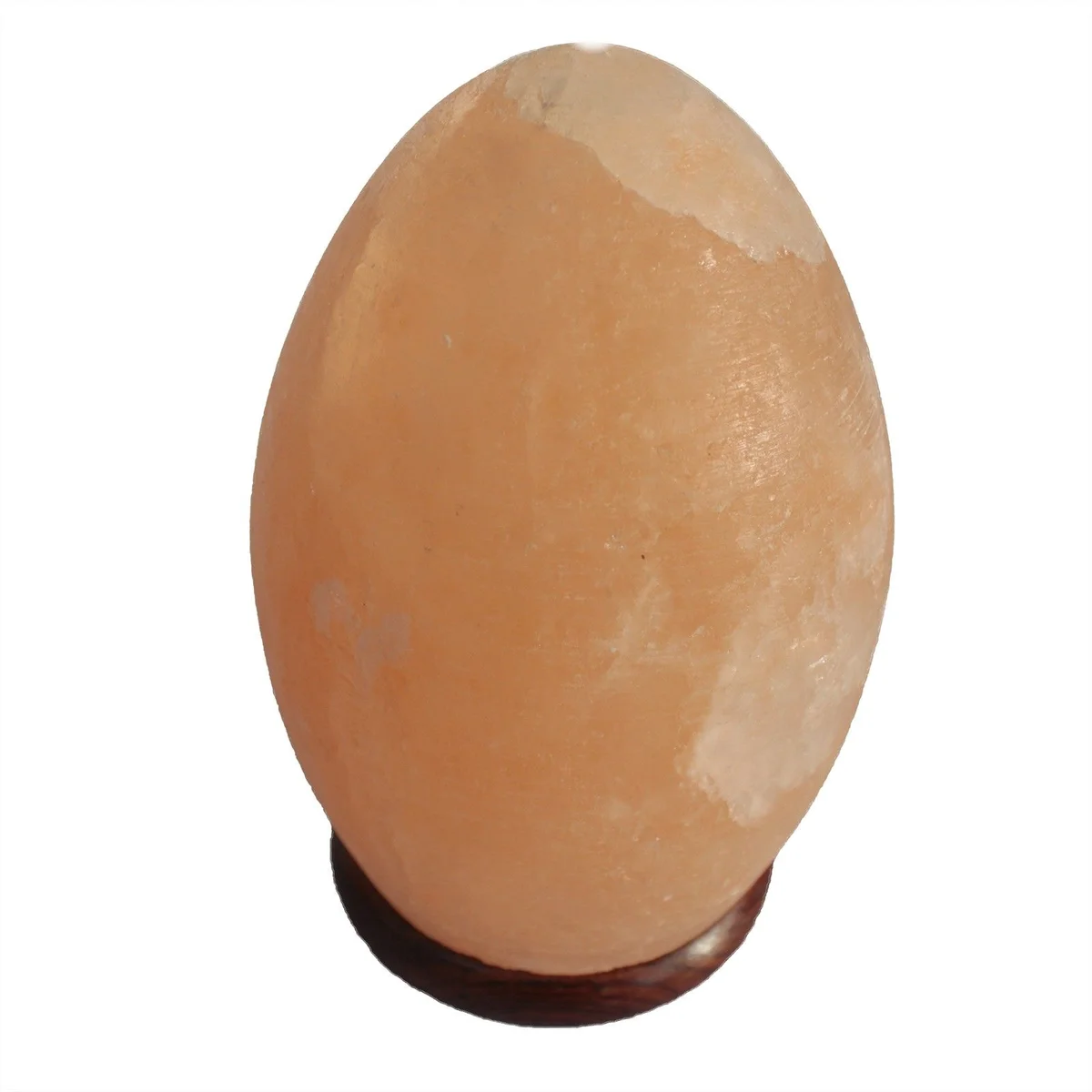 Salt lamp egg glowing softly on a wooden base against a white background