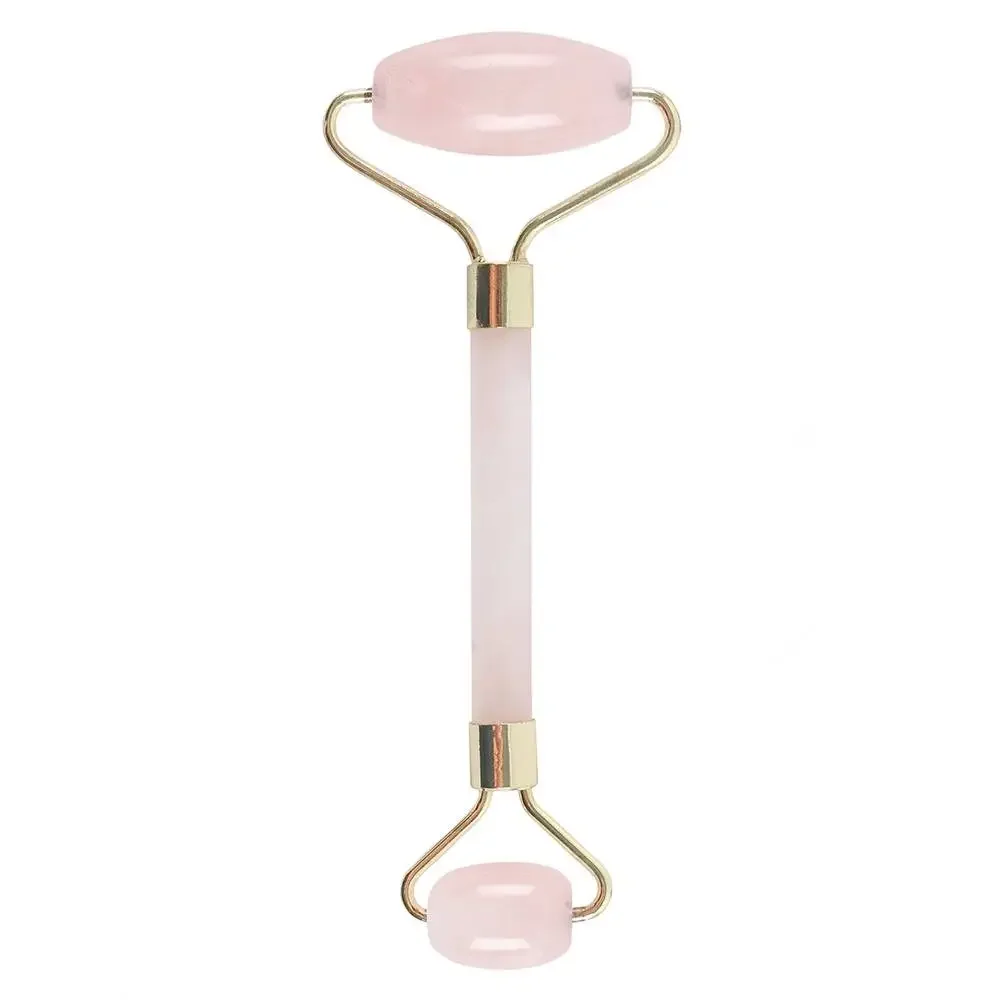 Rose quartz gemstone face roller with smooth pink stone rollers and wooden handle on white background