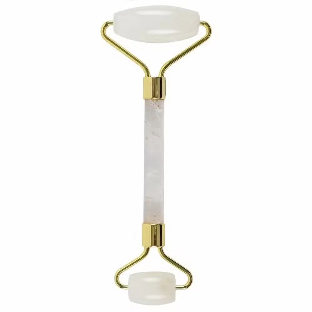 Rock Quartz natural stone roller with smooth, polished gemstone heads on a wooden surface, used for facial massage