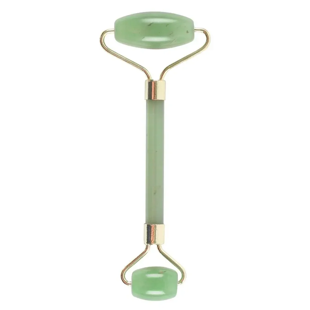 Green jade gemstone face roller with smooth cylindrical stones on a white background