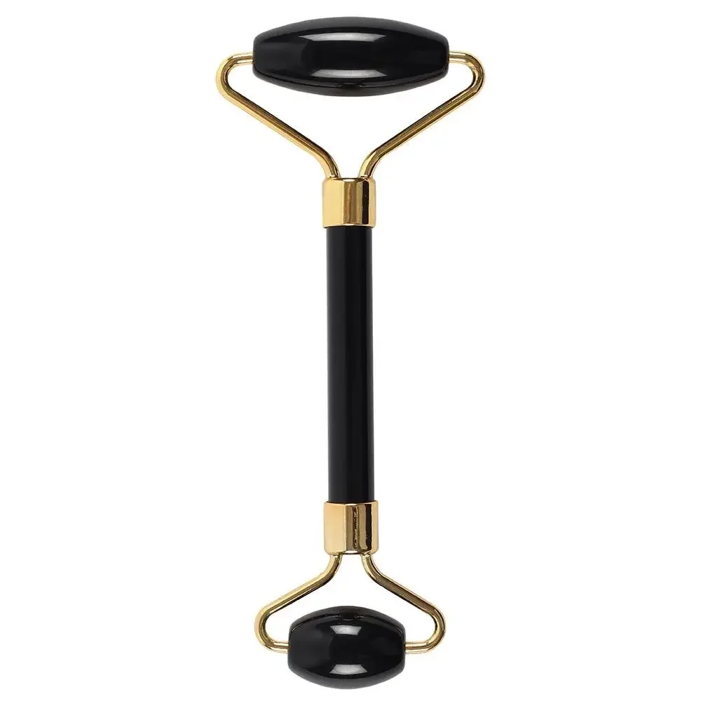 Black obsidian gemstone face roller with smooth polished stones and wooden handle for facial massage and skincare routines