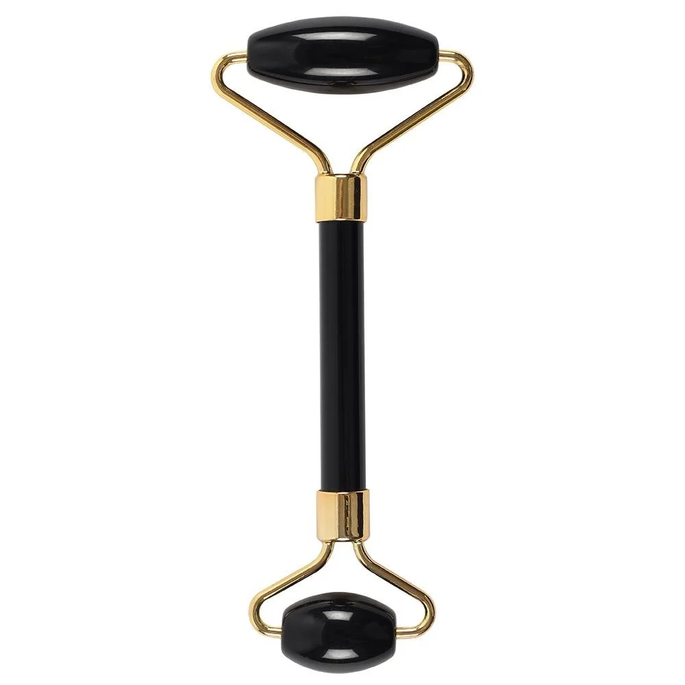 Black obsidian roller with smooth polished stone and wooden handle for facial massage and skincare routine
