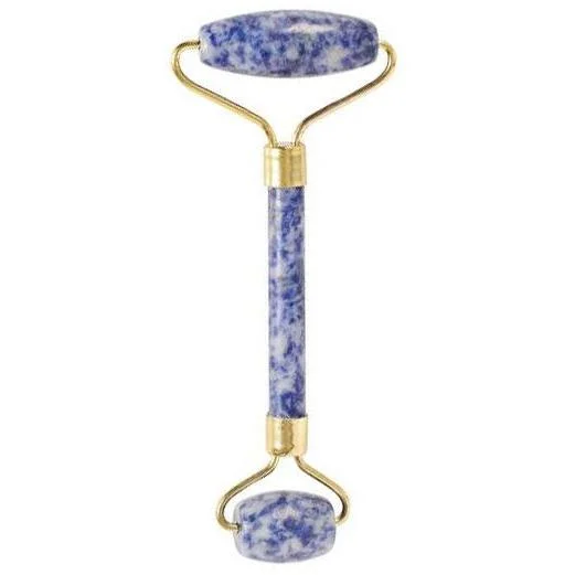 Sodalite gemstone facial massage roller with smooth blue stones and wooden handle against white background