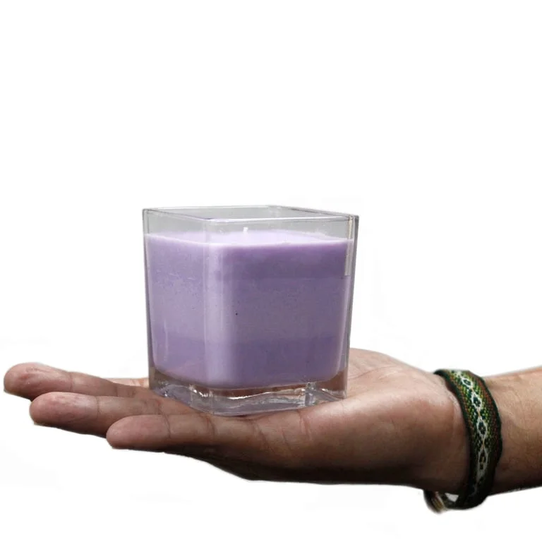 White label candle in clear glass jar with simple branding, placed on a kitchen counter.