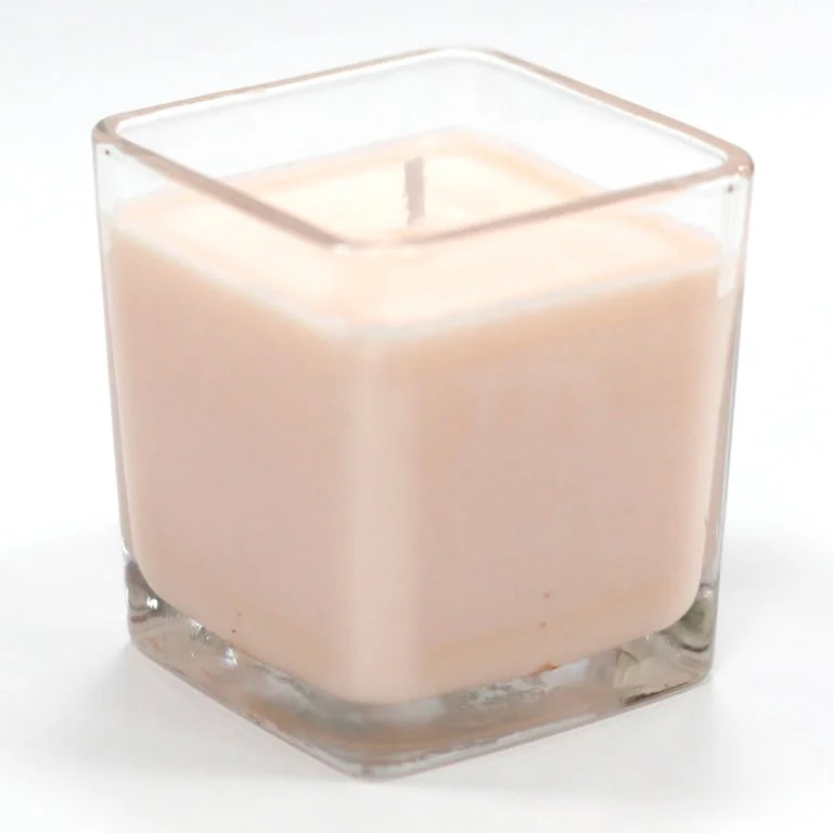 Soy wax candle in a glass jar with white label featuring Peach Smoothie fragrance.