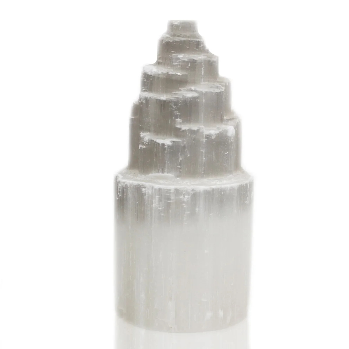 Natural selenite tower lamp standing 20 cm tall, polished white surface glowing softly.