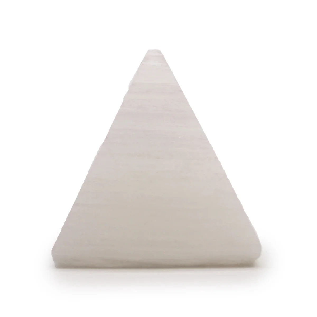 5 cm selenite pyramid with smooth translucent surfaces and natural crystal striations on a white background
