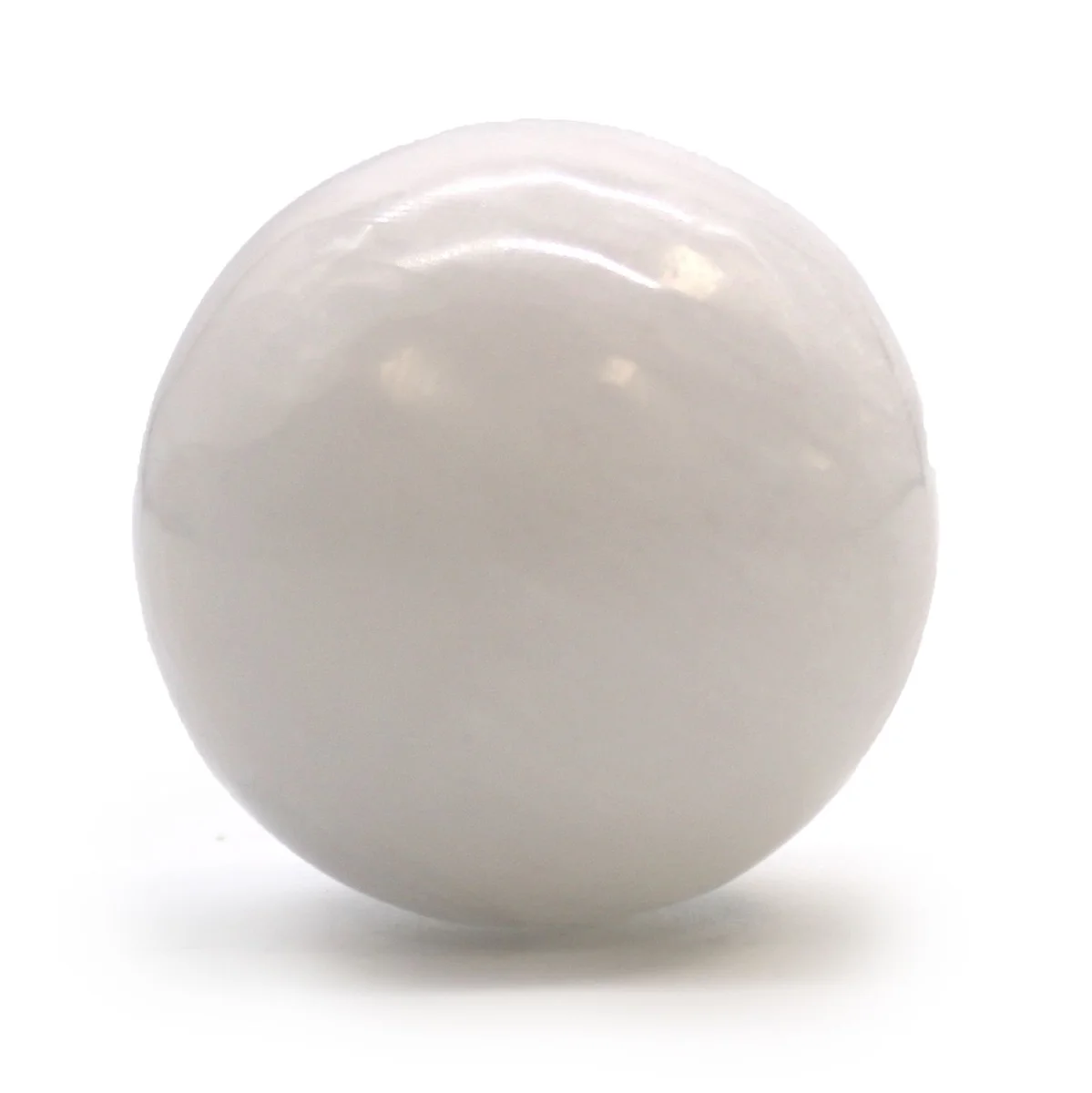 Smooth translucent selenite sphere measuring 5-6 cm on a plain white background