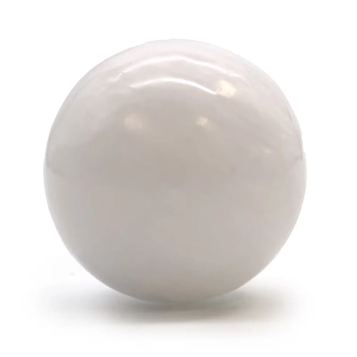 Decorative selenite orb measuring 5-6 cm with smooth, translucent white surface and natural striations on a plain background
