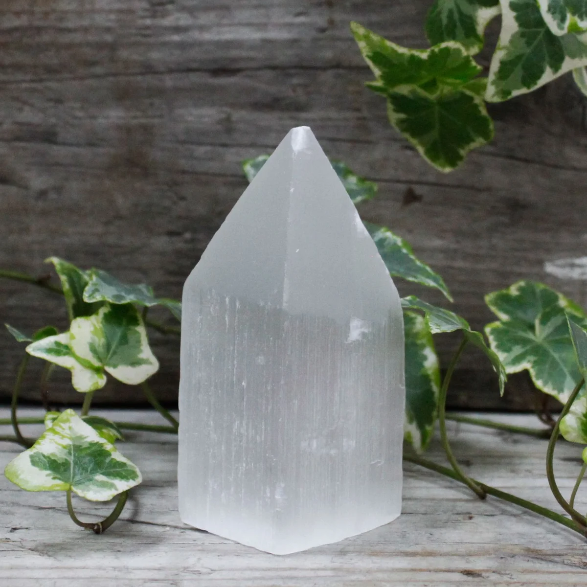 10 cm selenite tower with pencil point, displayed vertically.