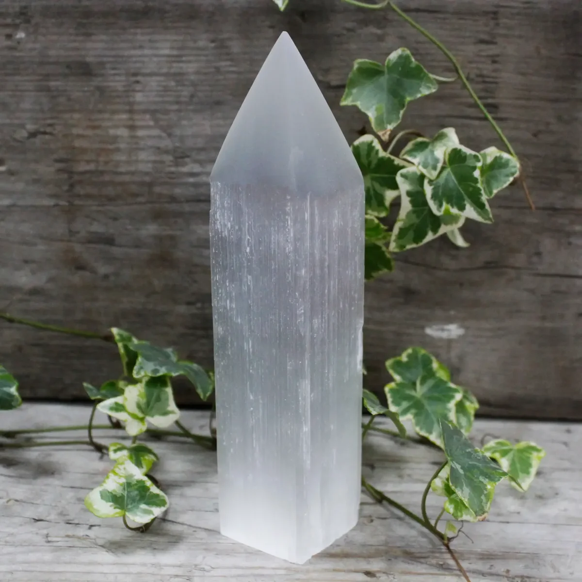 Tall 20 cm selenite pencil point tower, sleek white crystal used as selenite decor