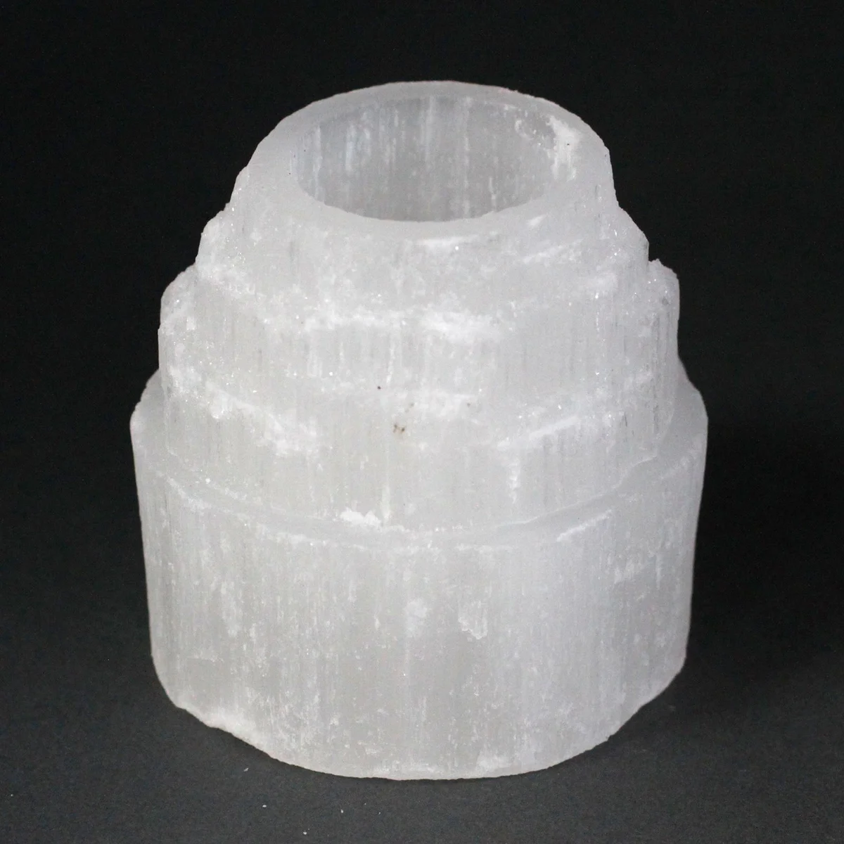 8 cm selenite candle holder displayed on light wood surface