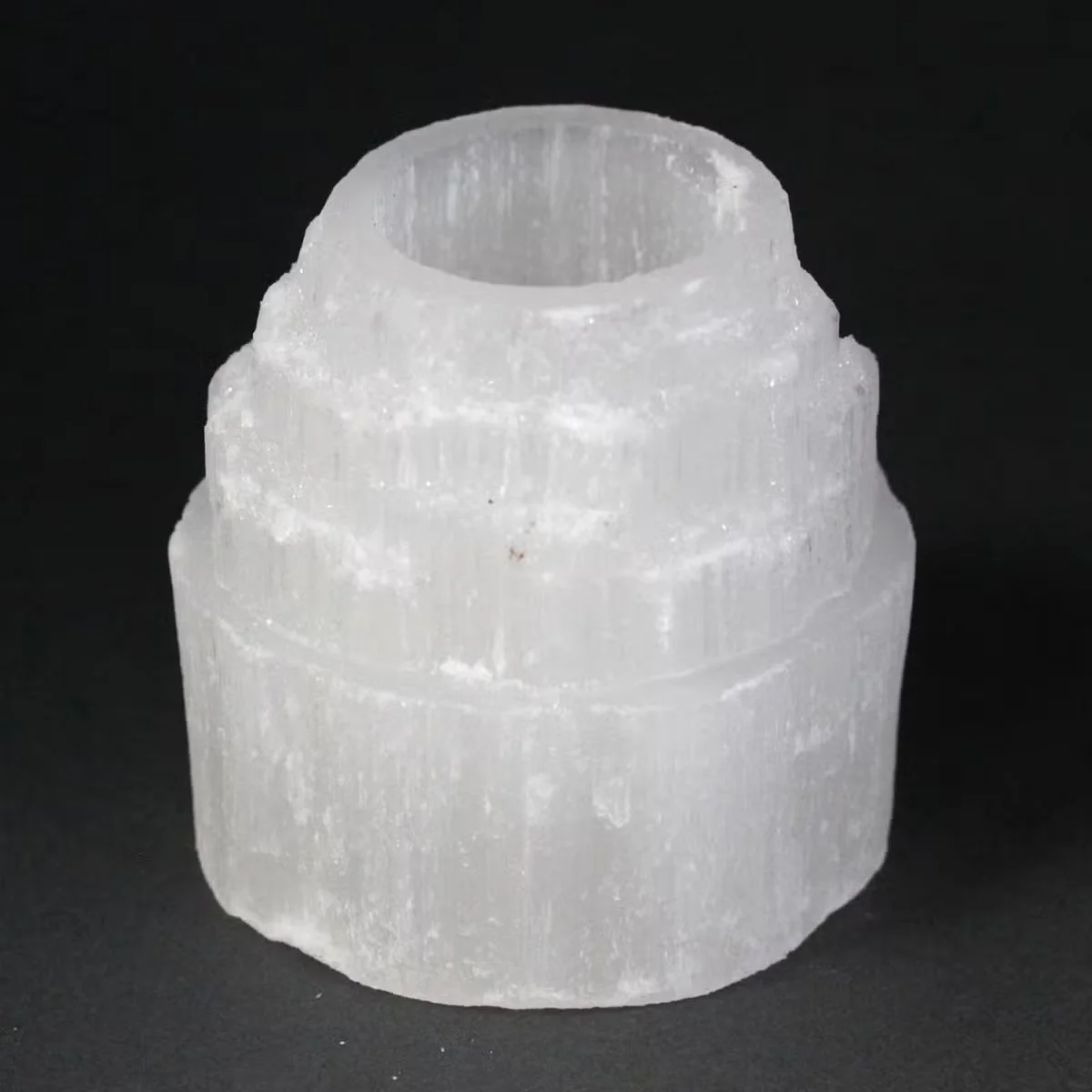 Crystal candle holder made of selenite in a mountain top shape, 8 cm tall.