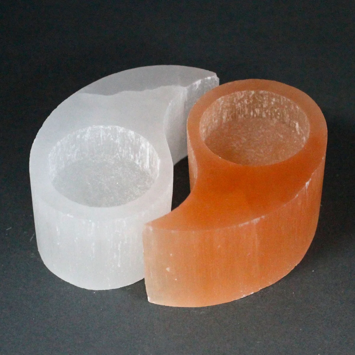 Selenite candle holder featuring yin‑yang design.