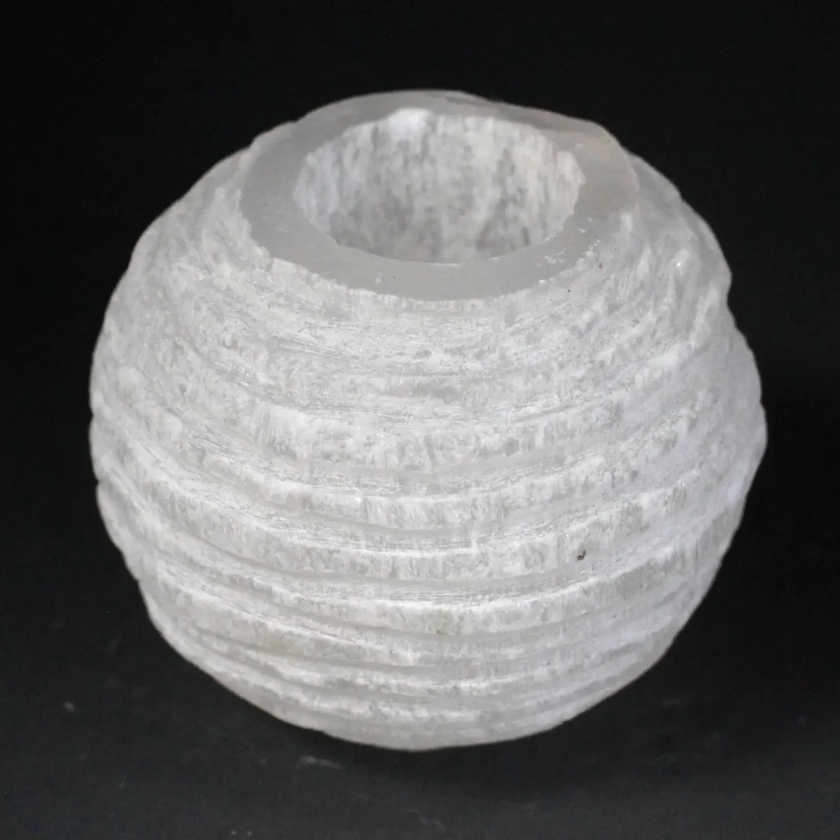 Selenite snowball candle holder, 8 cm, clear crystal sphere held by a candle flame.