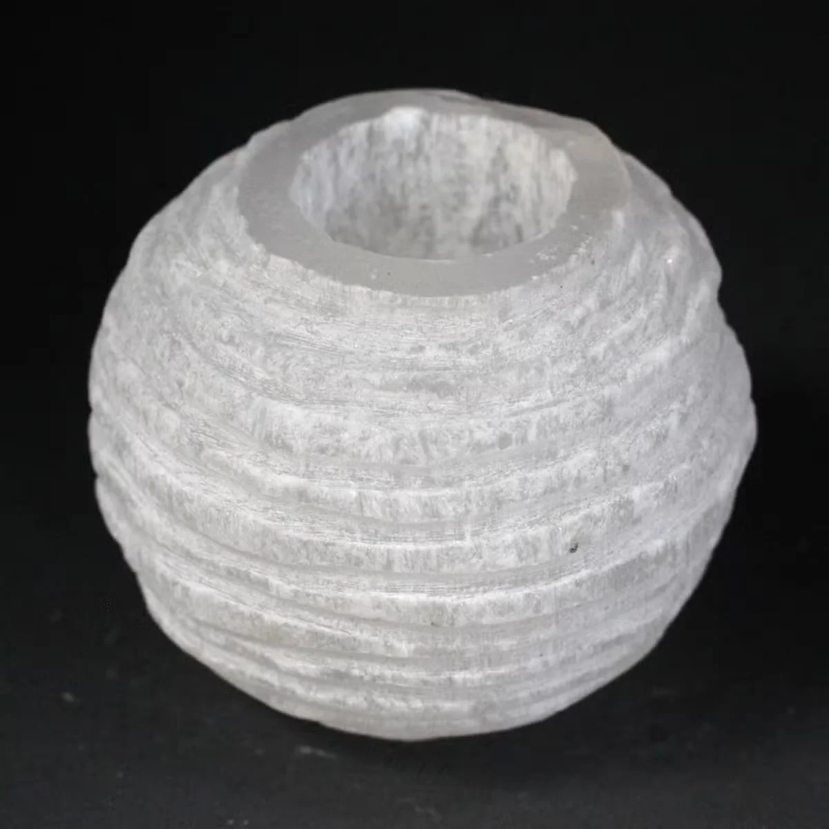 Decorative candle holder made of selenite in snowball shape, 8 cm tall.
