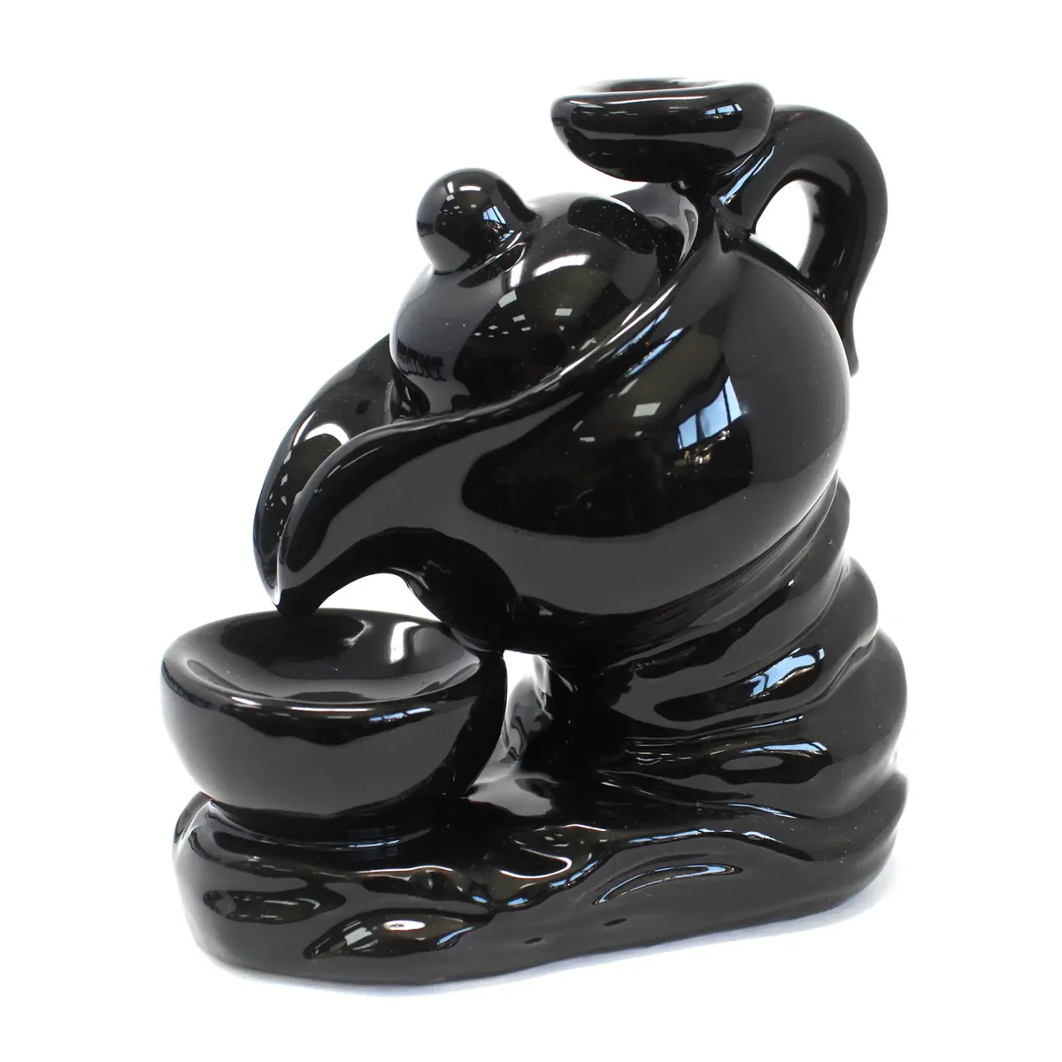 Ceramic tea pot incense burner designed for backflow incense cones releasing smoke through spout