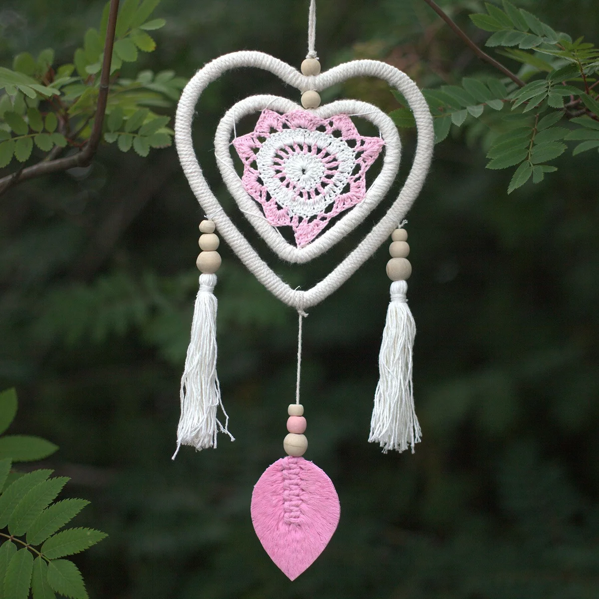 Medium pink heart dream catcher featuring a heart-in-heart design hanging on a white background