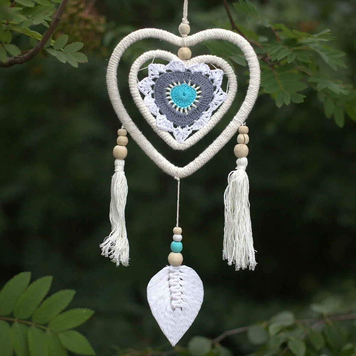 Medium blue heart dream catcher featuring a heart-in-heart design with intricate webbing and hanging feathers