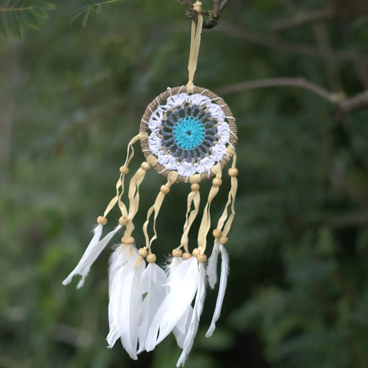 Pastel blue macramé wall hanging dream catcher with 9cm diameter in soft pastel colours