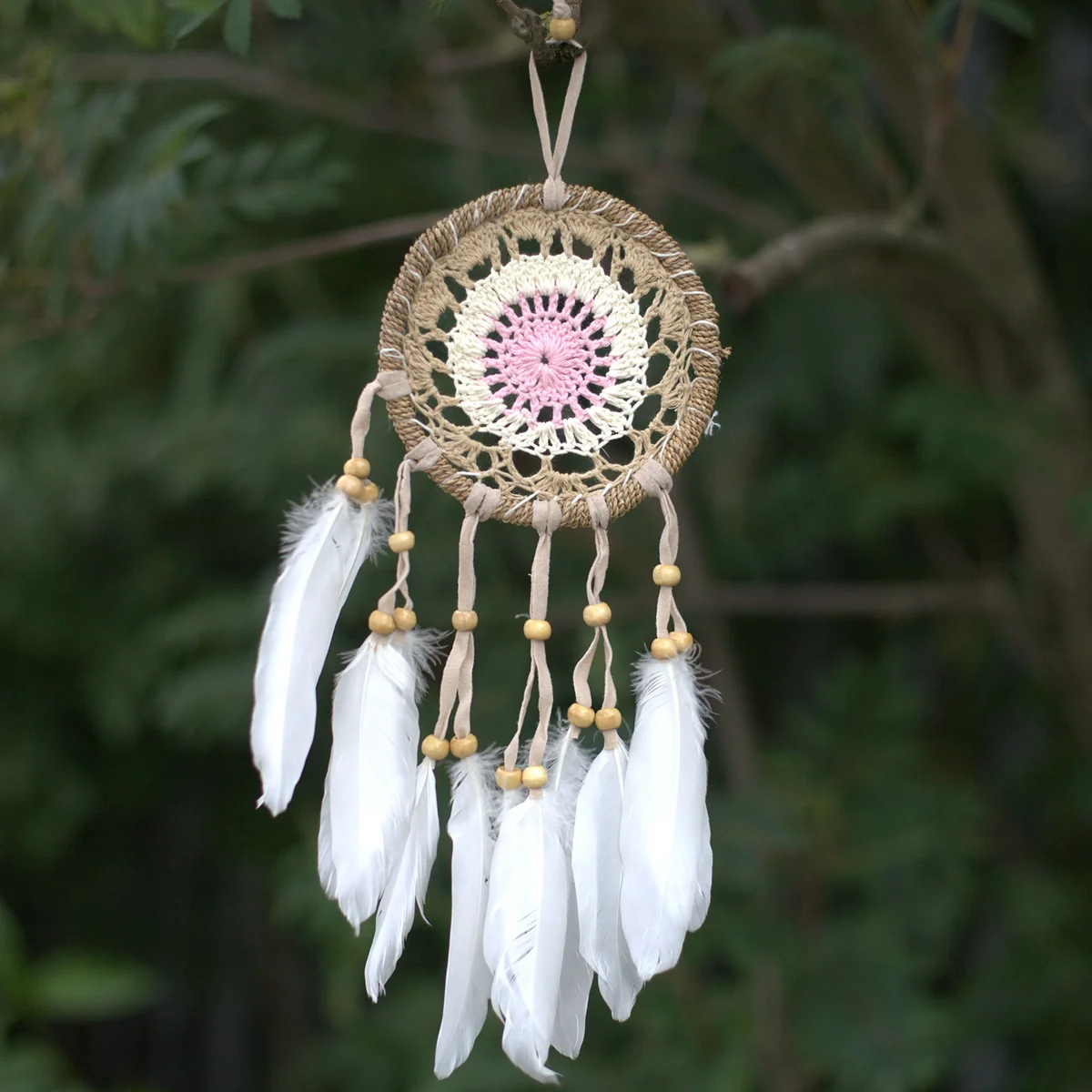 Pastel pink macramé dream catcher with intricate knots and feathers, 12cm, pink wall decor accessory