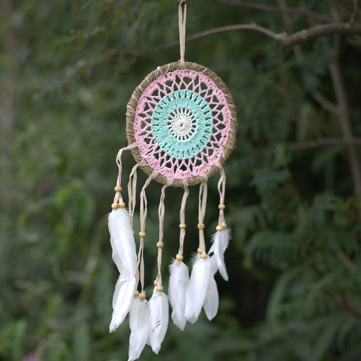 Pastel pink dream catcher with 16cm macramé design and hanging feathers in soft pastel colors