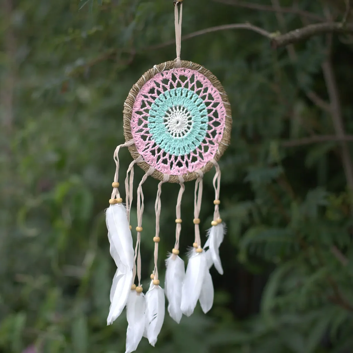 Pastel pink macramé dream catcher with intricate knotting and hanging tassels, 16cm diameter, assorted colours available
