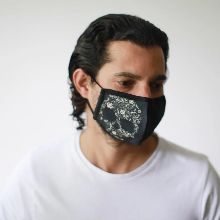 Reusable face mask featuring a floral skull design