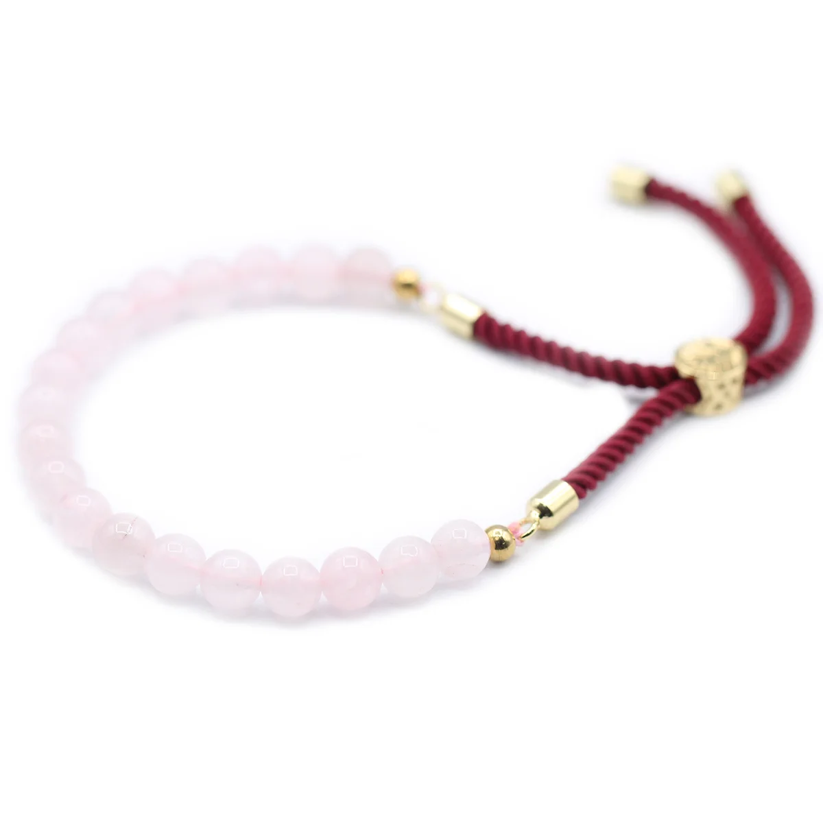 Close-up of 18K gold plated bordeaux string bracelet featuring a pink rose quartz gemstone centerpiece