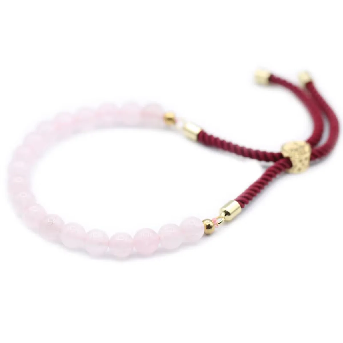 18K gold bracelet with Bordeaux string and rose quartz gemstone detail on a white background