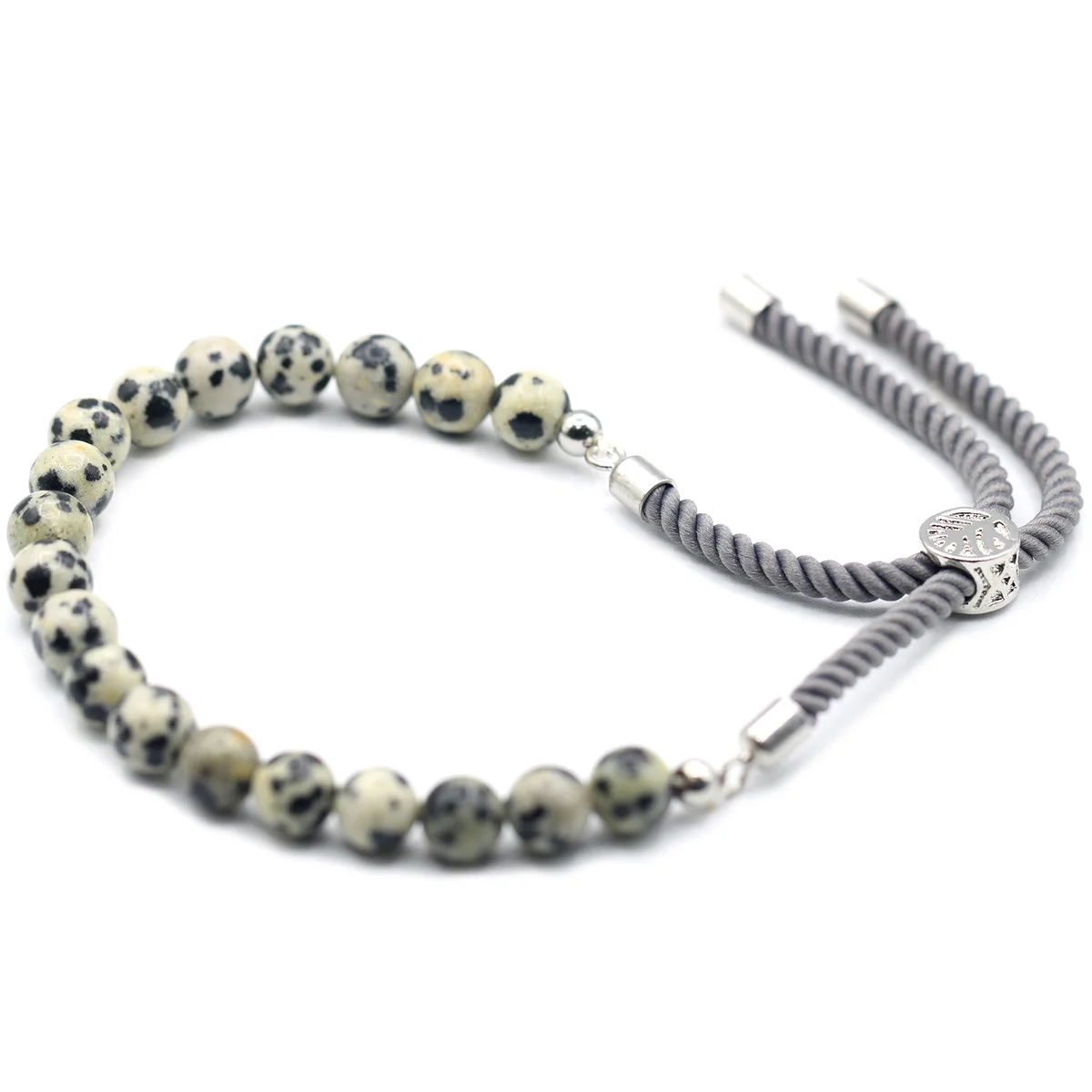 Close-up of 925 silver plated dalmatian jasper bracelet with charcoal string on white background