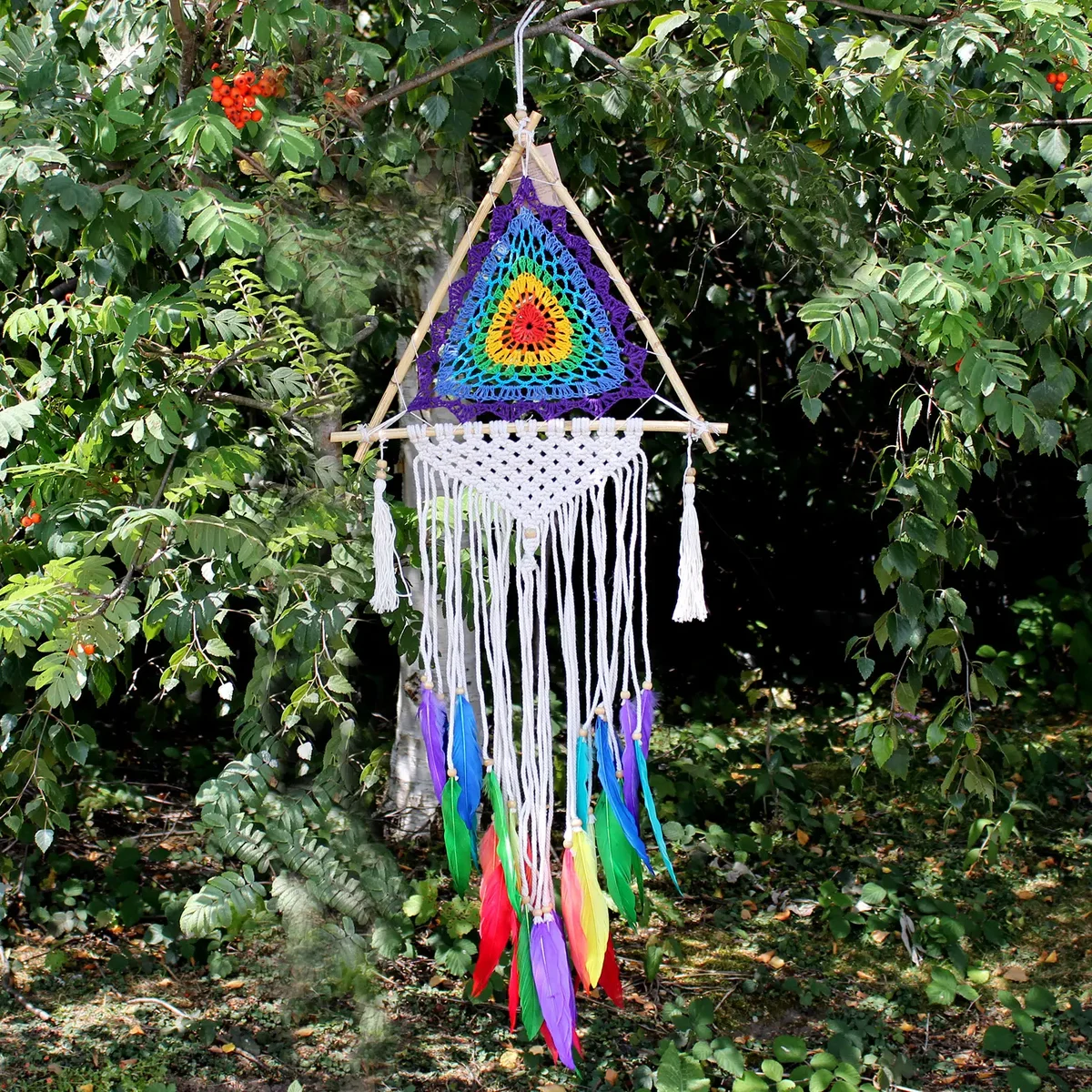 Medium dream catcher with multicolored pyramid design inspired by Bali craftsmanship on a white background