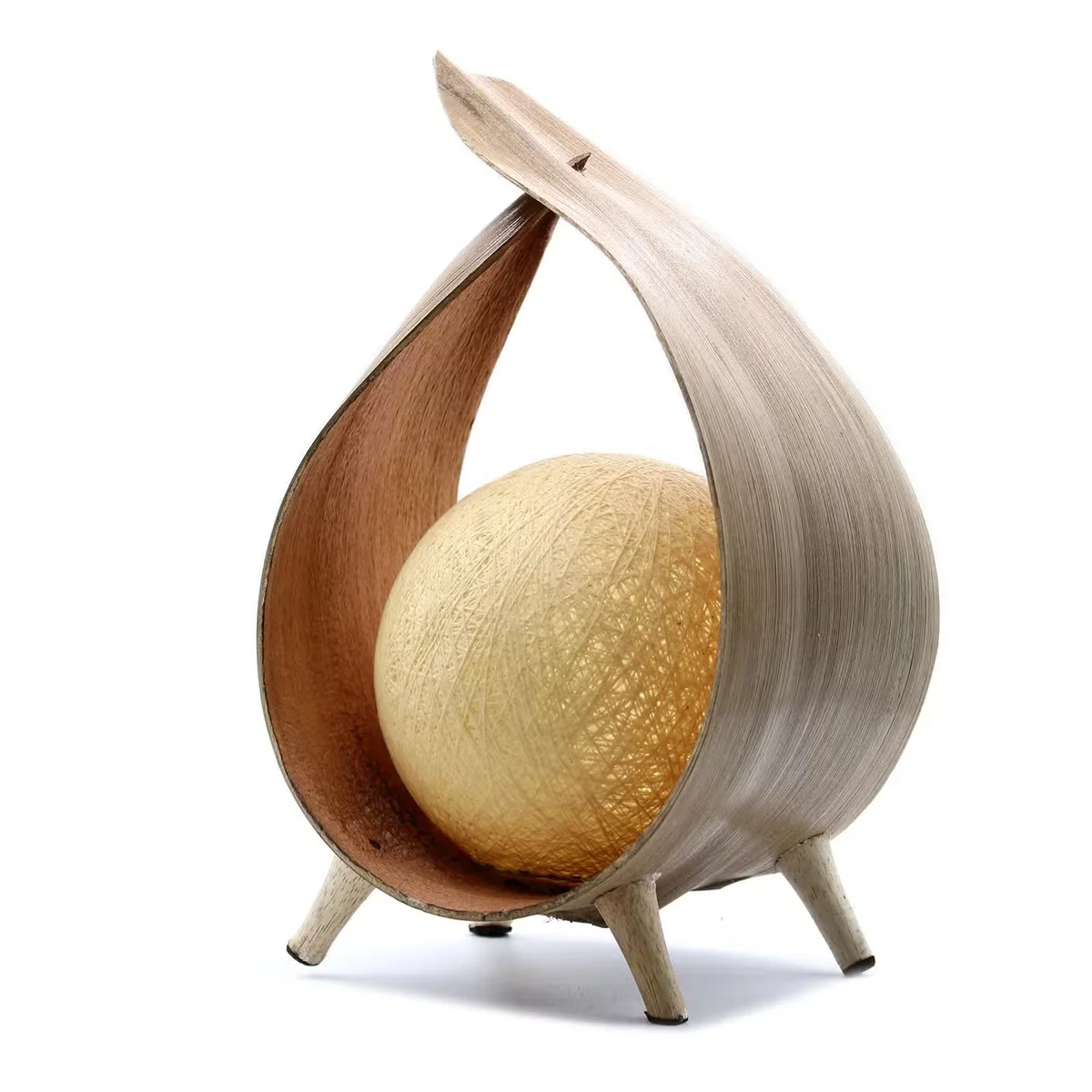 Natural wrapover lamp made from natural coconut shell with warm light glow, shown in image position 3