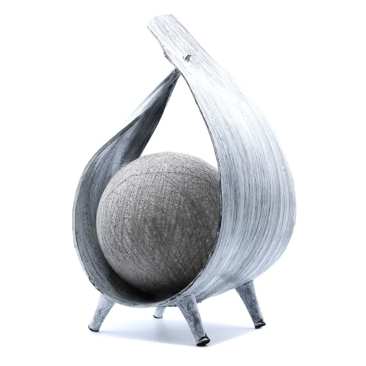 Greywash wrapover lamp made from natural coconut, glowing softly in a rustic setting