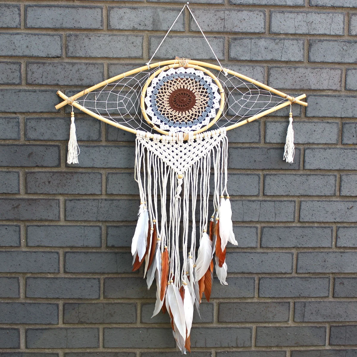 Large macrame protection dream catcher with white, grey, and brown threads featuring an evil eye design