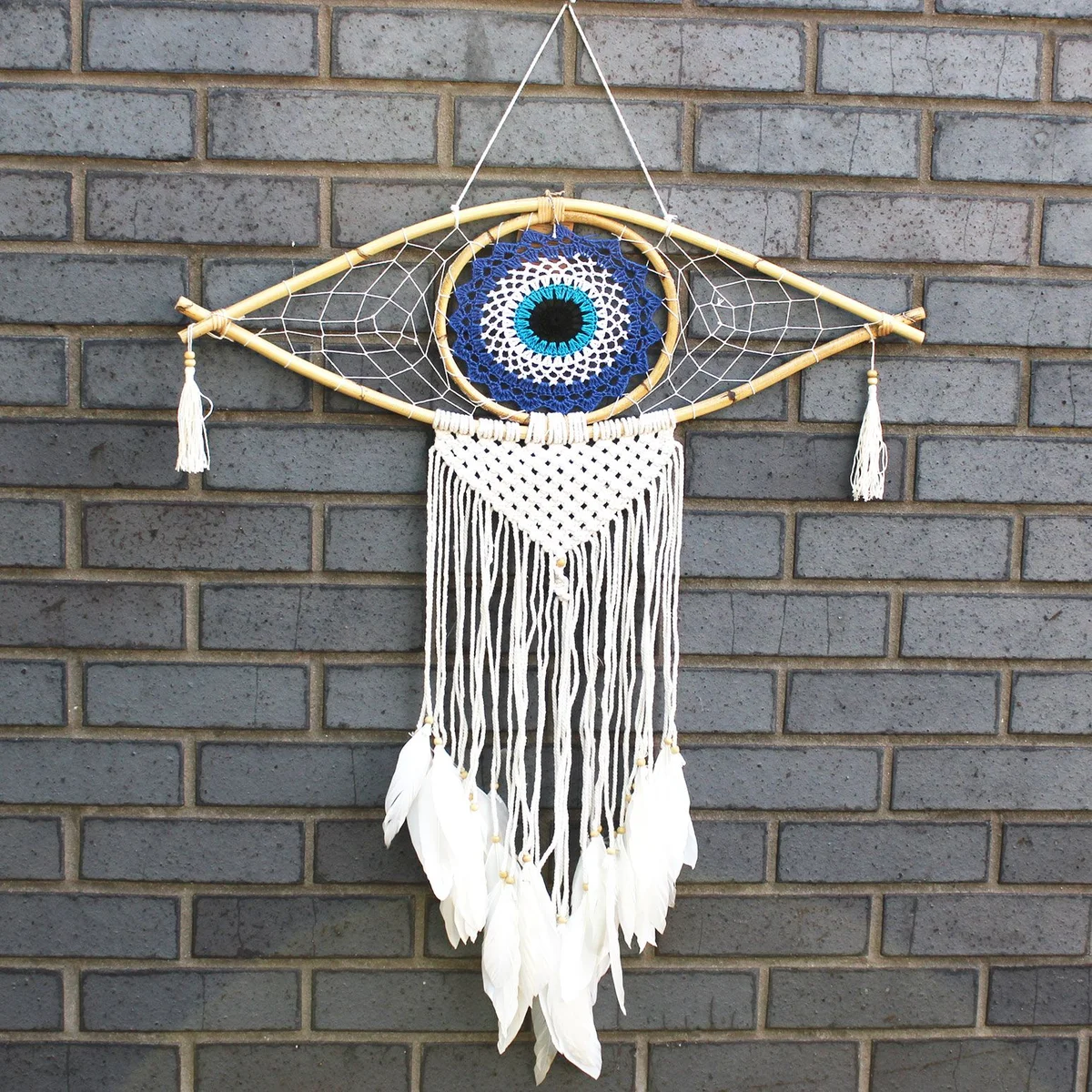 Large macrame protection dream catcher in blue, white and black with an evil eye charm