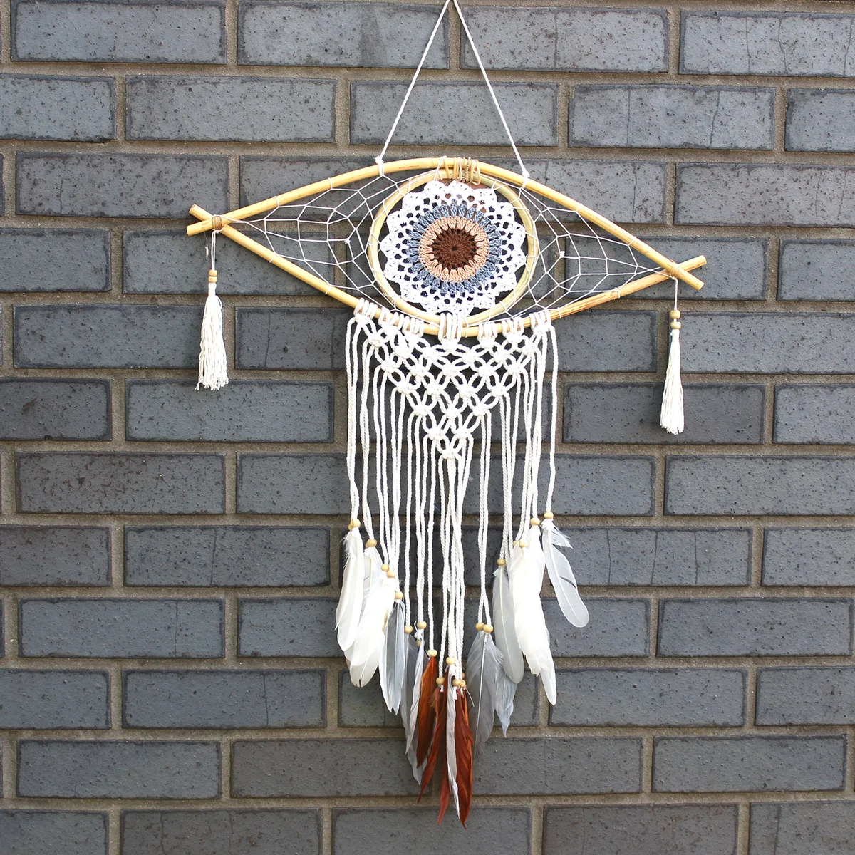 Medium macramé dream catcher with evil eye decor in white, grey and brown.