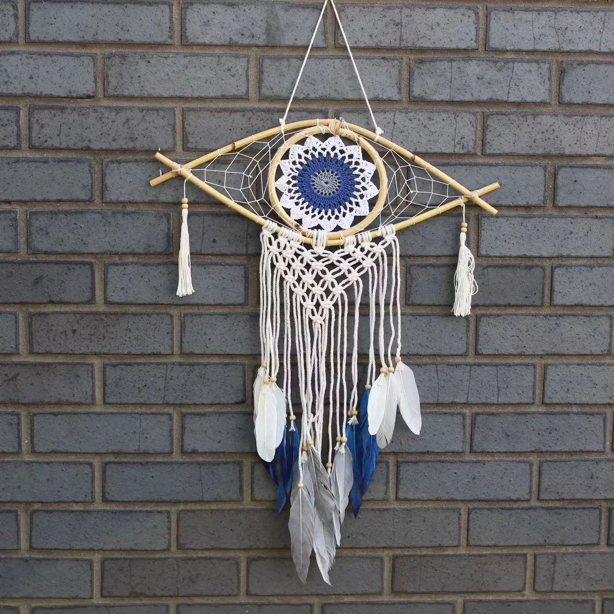 Medium macrame white blue grey dream catcher with an evil eye centerpiece and colourful tassels