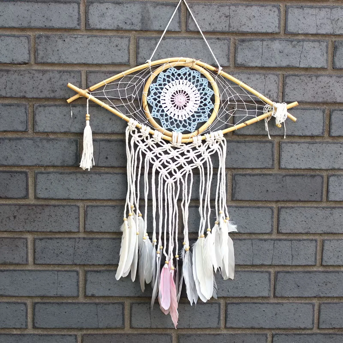 Medium macrame dream catcher with blue, white, pink strands and an evil eye — stylish blue white pink decor