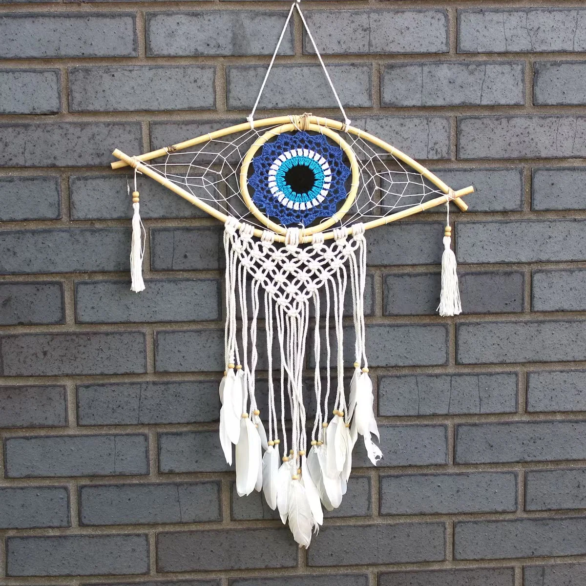 Blue white black dream catcher with mid‑size macramé frame and styled evil eye charm
