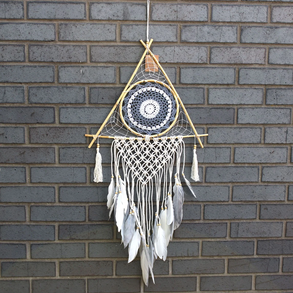 Large macrame dream catcher in white and grey, pyramid shape crafted from braided rope
