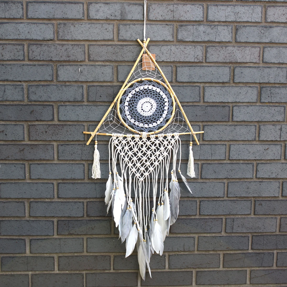 Large white and grey macrame pyramid dream catcher with interwoven cords and protective circle.