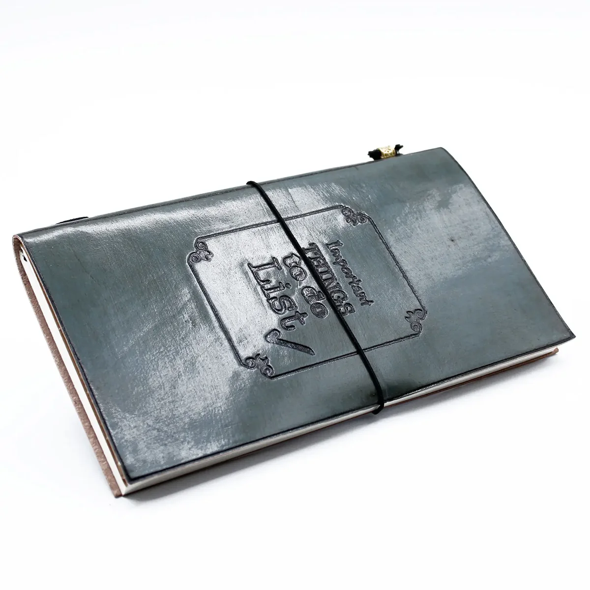 Grey handmade leather journal with embossed title "Important Things To Do", closed cover.