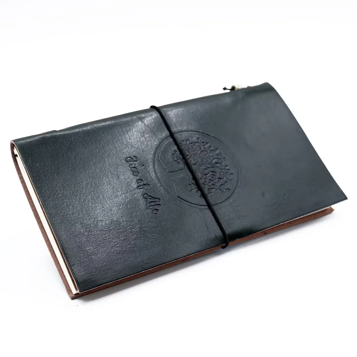 Handmade journal with a green leather cover featuring a Tree of Life design, showing textured leather and open pages.