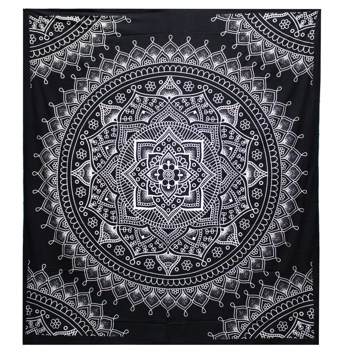 Black and white bedspread with lotus flower pattern paired with matching wall hanging on a bedroom wall.