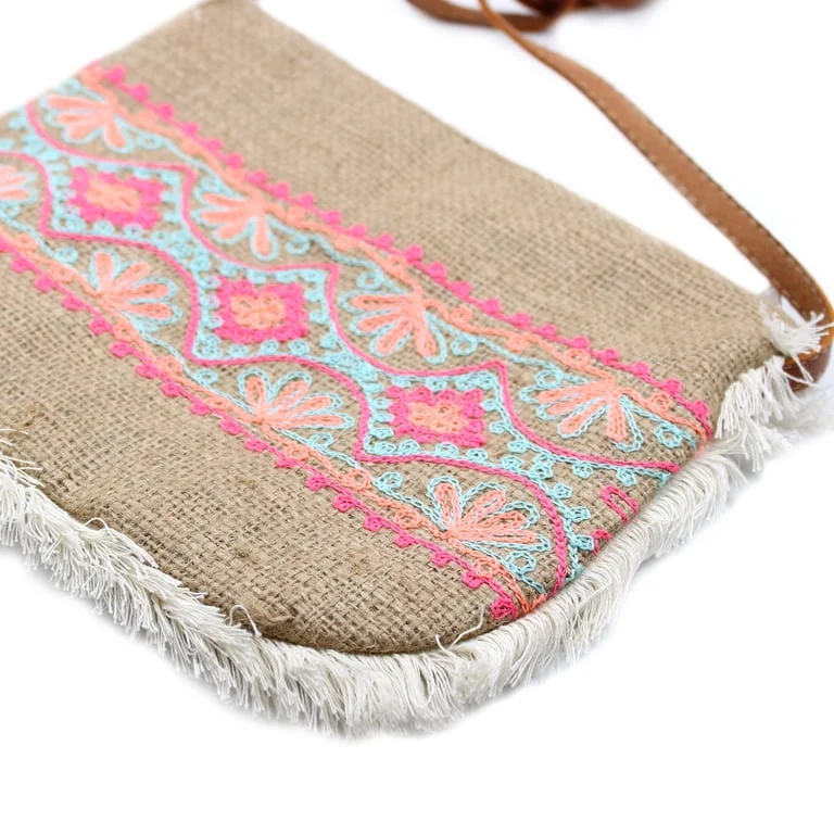 Vibrant fringe handbag with summer pattern embroidery, displayed on a simple backdrop.