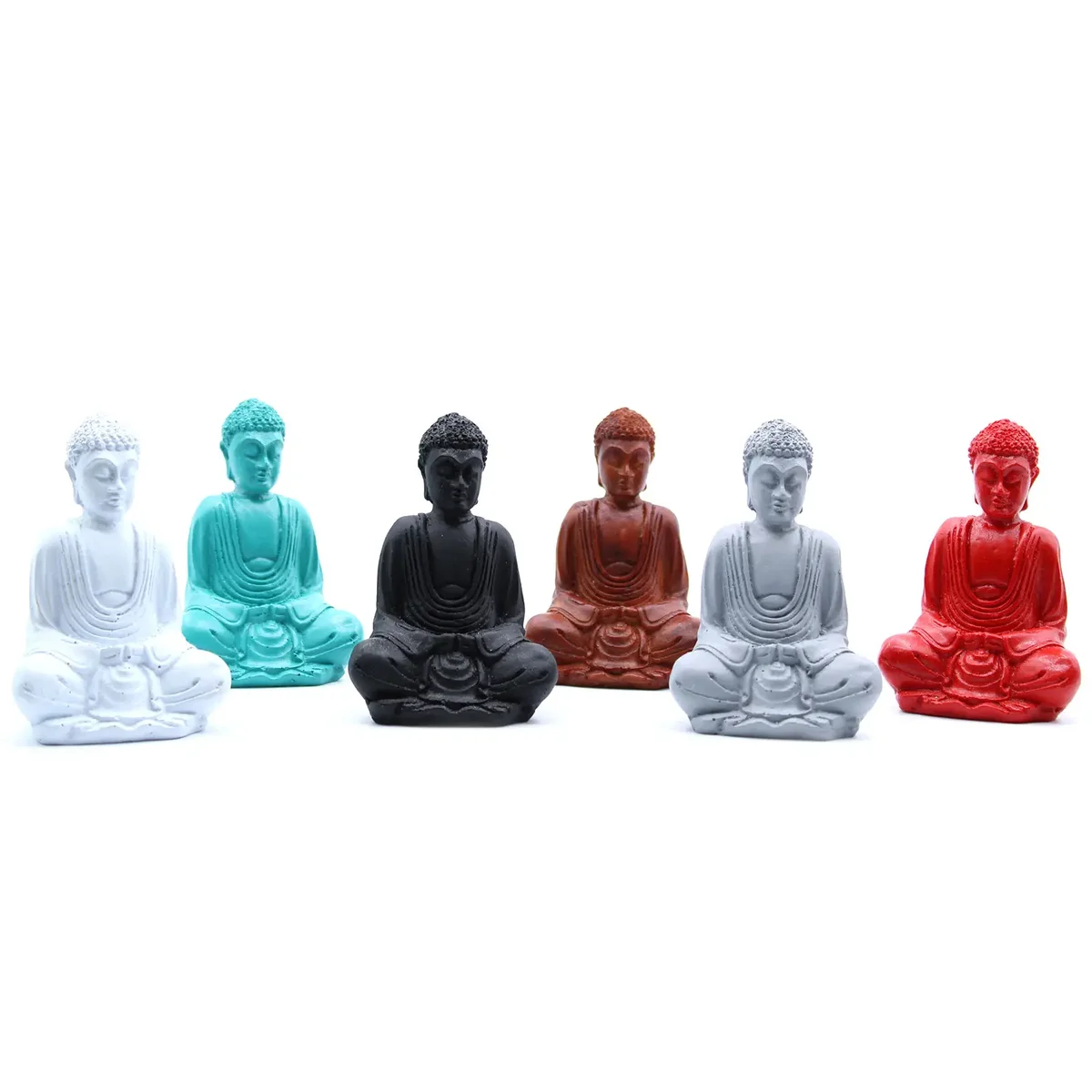 Small matt mini Buddha statues in assorted colours arranged together on a white background