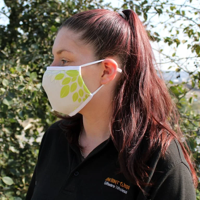 Reusable fashion face covering in green leaf pattern, folded neatly in a pouch – soft, breathable, adult size.