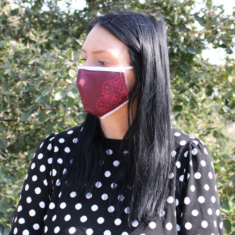 Red mandala face mask featuring heart design, soft fabric, reusable, suitable for adults.