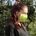 Adult face mask with pet feet pattern, showing a reusable fashion covering.